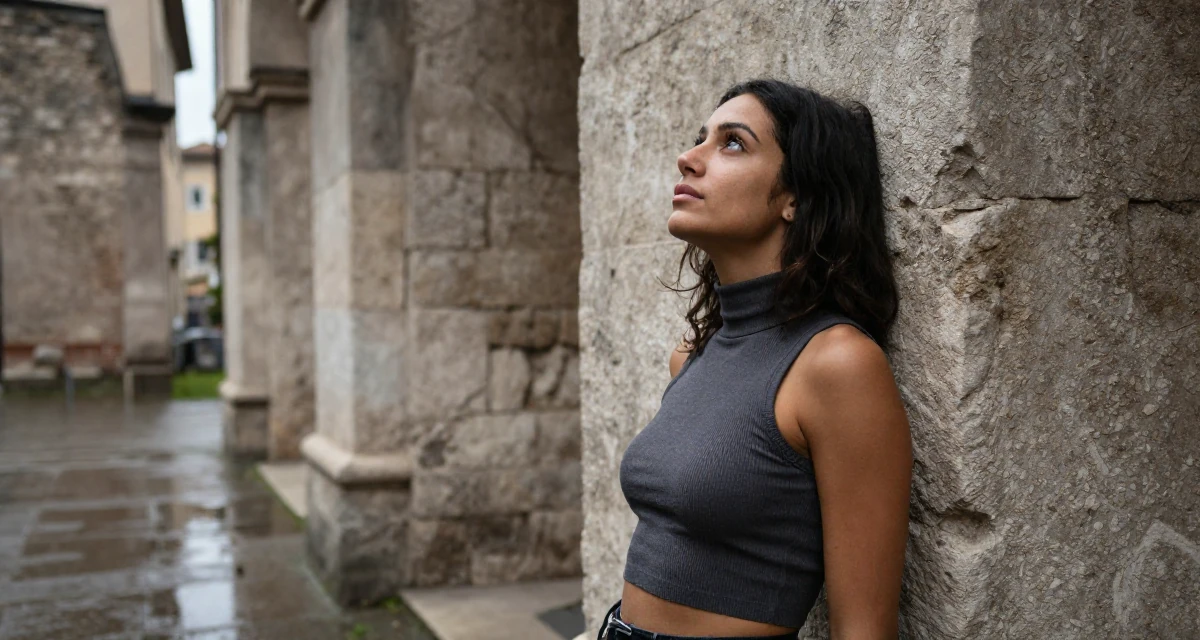 A reserved Female From Italy, based in Milan, graduated from a design school majoring in sensual visual communication in their 27, feeling stuck between passion and survival,
wearing a high-neck sleeveless crop top showing toned arms, gazing at the sky in a ancient stone ruins.