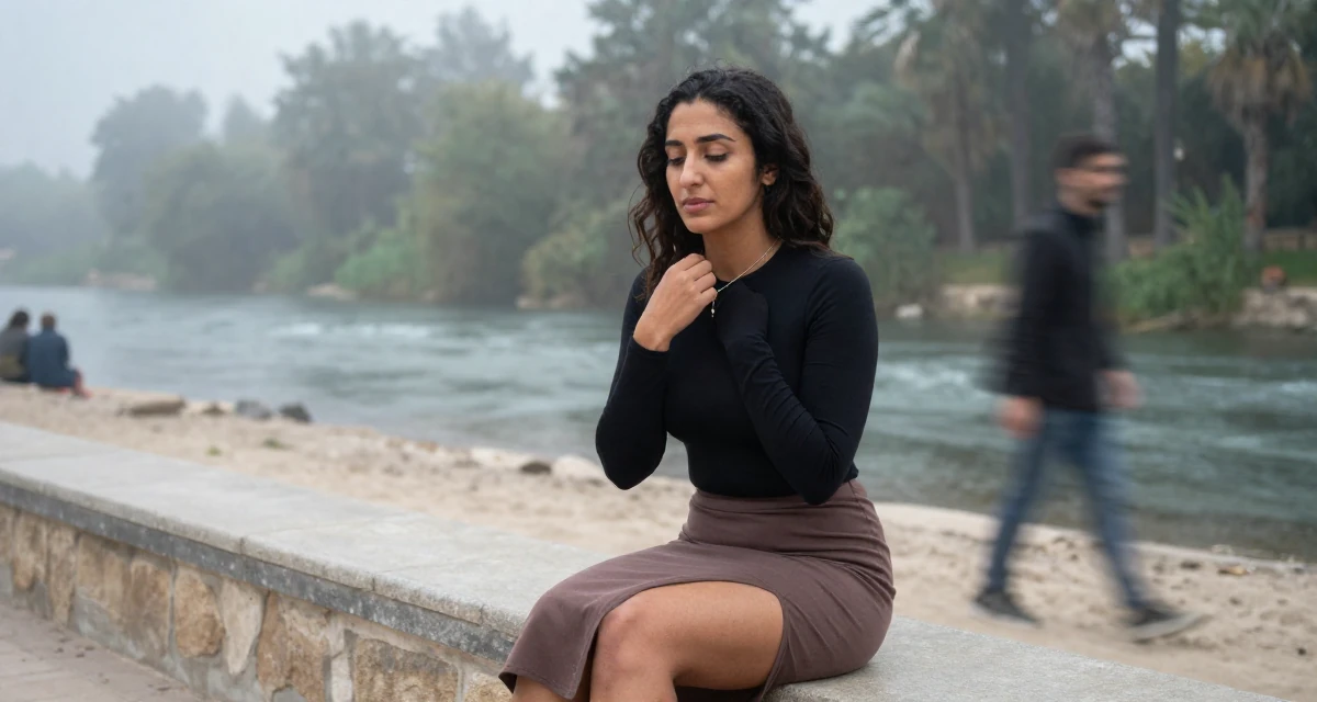 A quietly content Female From Cairo Egypt, studied anthropology in their 29, dealing with social pressure to “settle down”, wearing a tight long-sleeve bodysuit and a slit midi skirt, touching a necklace in a beach promenade.