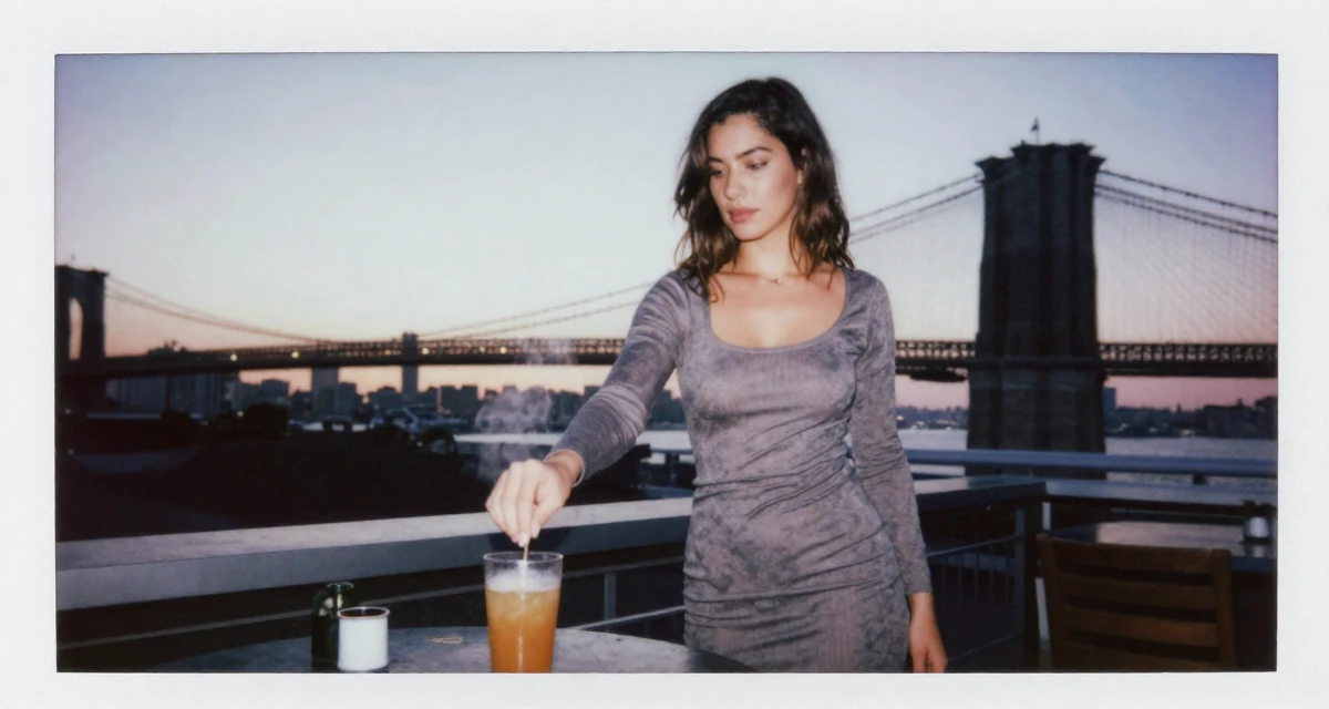 A ambitious Female From Cyprus, based in Limassol, graduated from a communication school majoring in alluring content design in their 23, realizing “less is more” in seductive storytelling, wearing a tight knit midi dress with long sleeves, stirring a drink in a rooftop terrace at sunset.