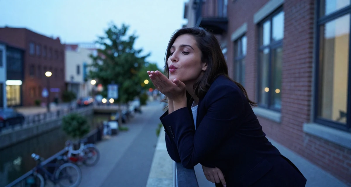 A friendly Female From Canada, trained in advertising and branding in their 22, building early digital portfolios, wearing a sharp business casual attire, blowing a kiss in a bridge walkway.