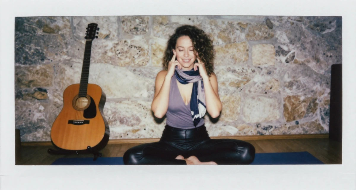 A pleased Female From Austria, based in Graz, graduated from an arts academy majoring in emotional portrait direction in their 22, confronting self-doubt in early career roles, wearing a wrap-front bodysuit and leather leggings, adjusting a scarf in a yoga studio.