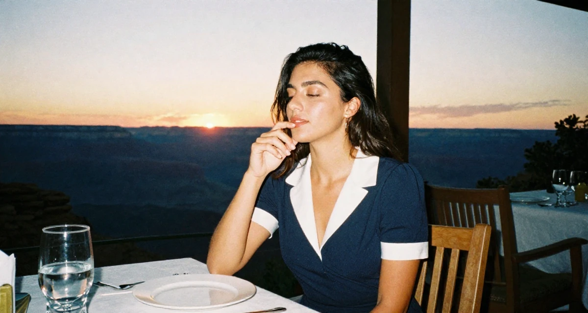 A sensual Female Once a junior photographer, now the subject of her own shoots in their 25, accepting that growth is slower than motivational quotes claim, wearing a navy blue dress with white collar and cuffs, taking a deep breath in a dining room.