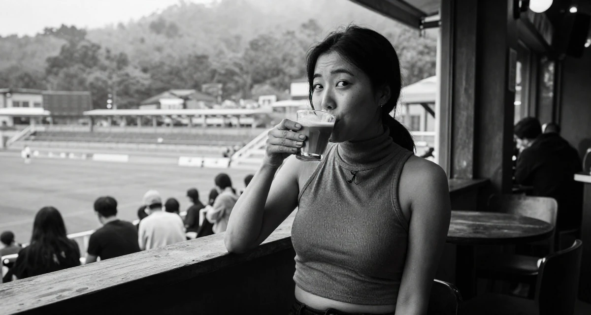 A playful Female From South Korea, based in Busan, graduated from a design institute majoring in visual communication in their 36, expert in coffee culture and brewing, wearing a high-neck sleeveless crop top showing toned arms, sipping a latte in a cinema entrance.